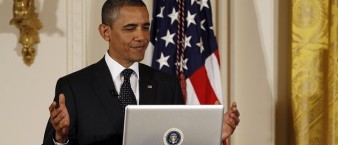 U.S. President Barack Obama reacts after tweeting at his first ever Twitter Town Hall in the East Room at the White House in Washington