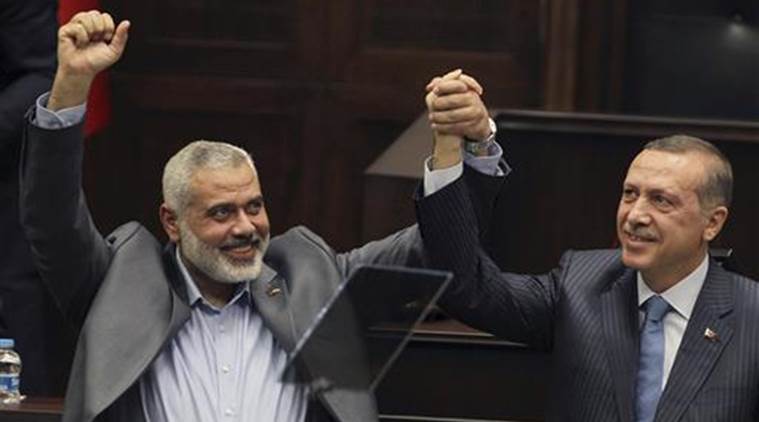 Terrorist Hamas leader Ismail Haniyeh, left, and Turkish Prime Minister Recep Tayyip Erdogan, salute together the lawmakers and supporters of Erdogan’s Islamic Party at the Parliament in Ankara.