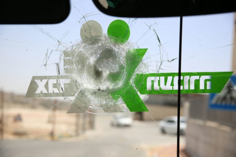 The windshield of a bus damaged near Hizme.